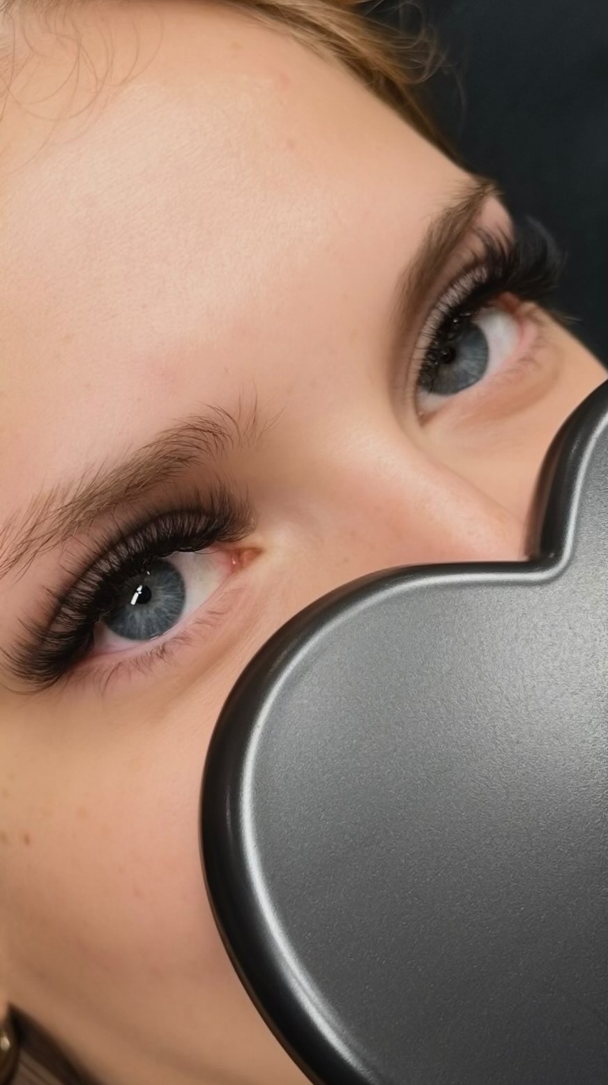 Dramatic volume lashes — blue eyes in heart mirror