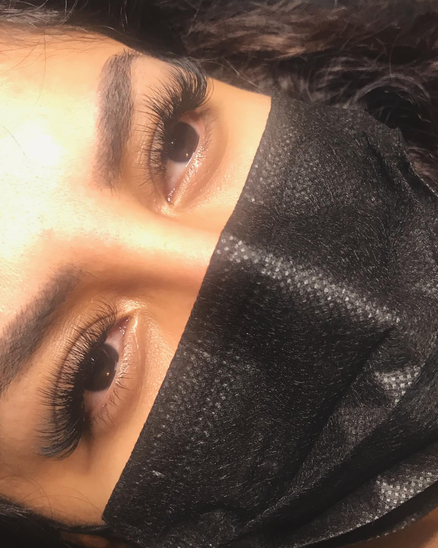 Volume lashes in warm studio lighting
